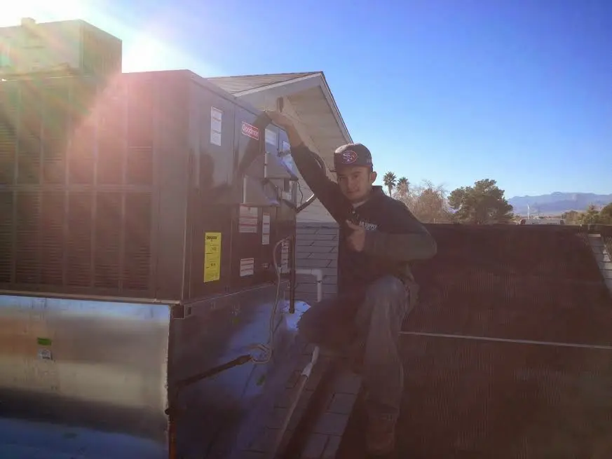 HVAC technician performing AC Tune-Up on a rooftop unit in Rowland Heights