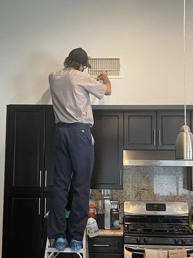 Technician inspecting an air vent during HVAC service in Rowland Heights